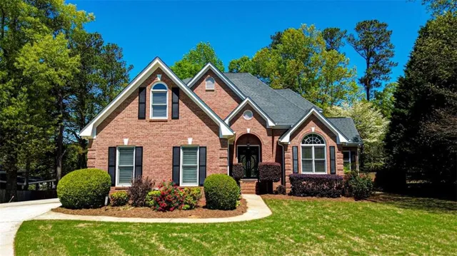 a front view of a house with a yard