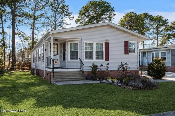 a front view of house with yard and green space