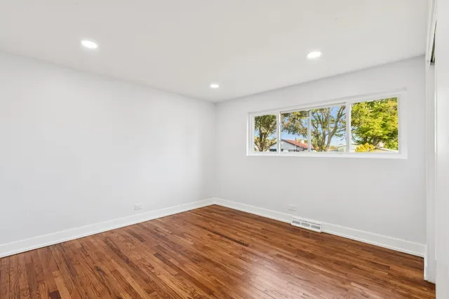 a view of room with wooden floor and window