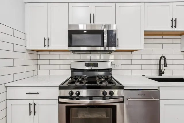 a stove top oven sitting inside of a kitchen
