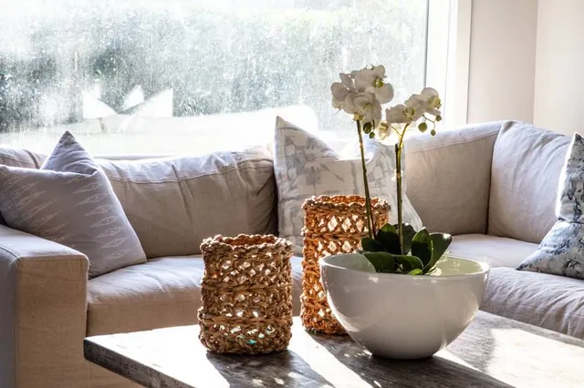 a living room with furniture and flowers