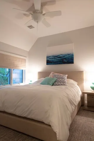 a bedroom with a bed and a night stand