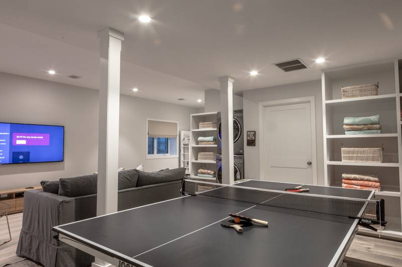 16 Roosevelt Road Montauk, NY 11954 - Photo 20 of 30 a living room with furniture pool table and a flat screen tv