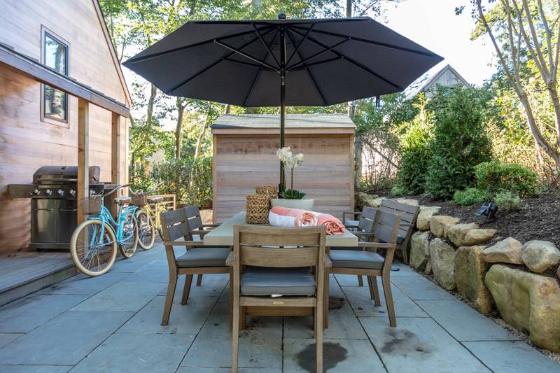 16 Roosevelt Road Montauk, NY 11954 - Photo 26 of 30 a view of a patio with table and chairs under an umbrella