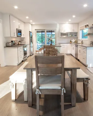 a kitchen with kitchen island white cabinets and refrigerator