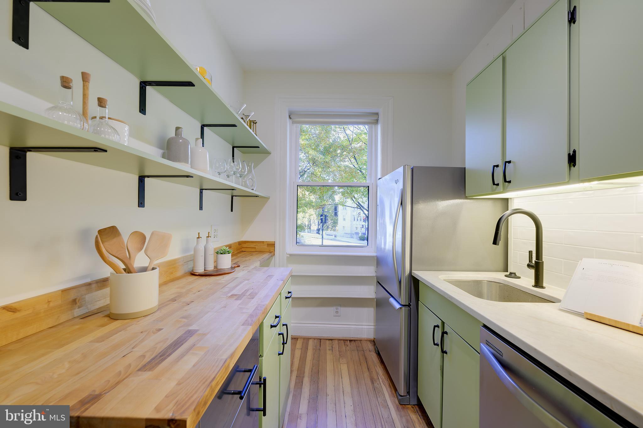 3100 Connecticut Avenue Northwest, Unit 145 Washington, DC 20008 - Photo 15 of 35 a kitchen with sink a microwave cabinets and stainless steel appliances