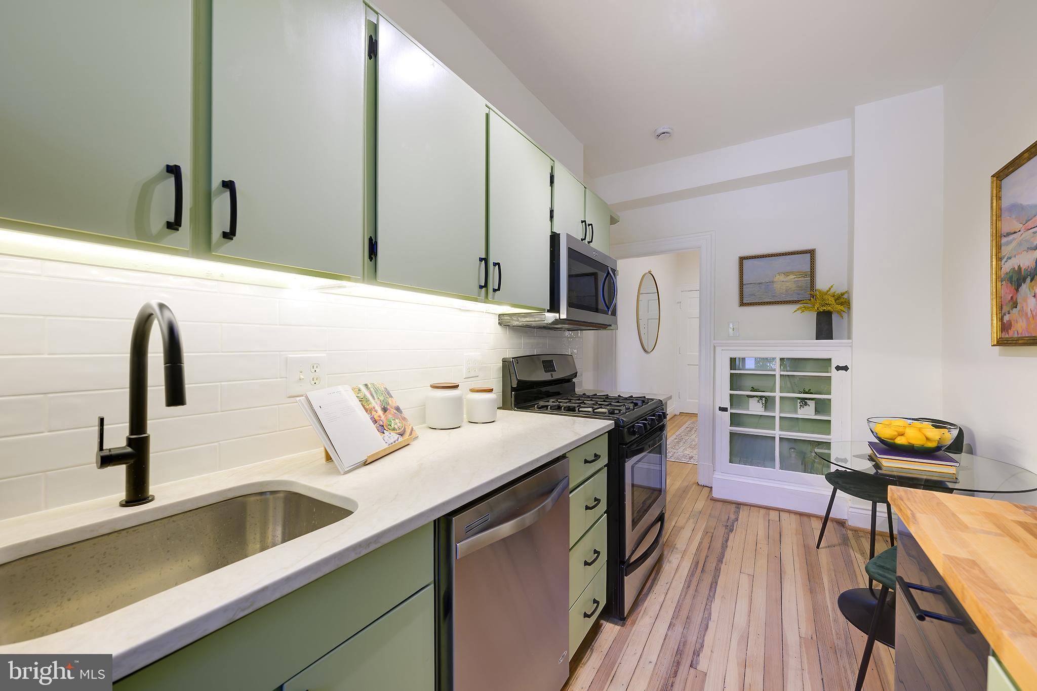 3100 Connecticut Avenue Northwest, Unit 145 Washington, DC 20008 - Photo 17 of 35 a kitchen with a sink a stove and cabinets
