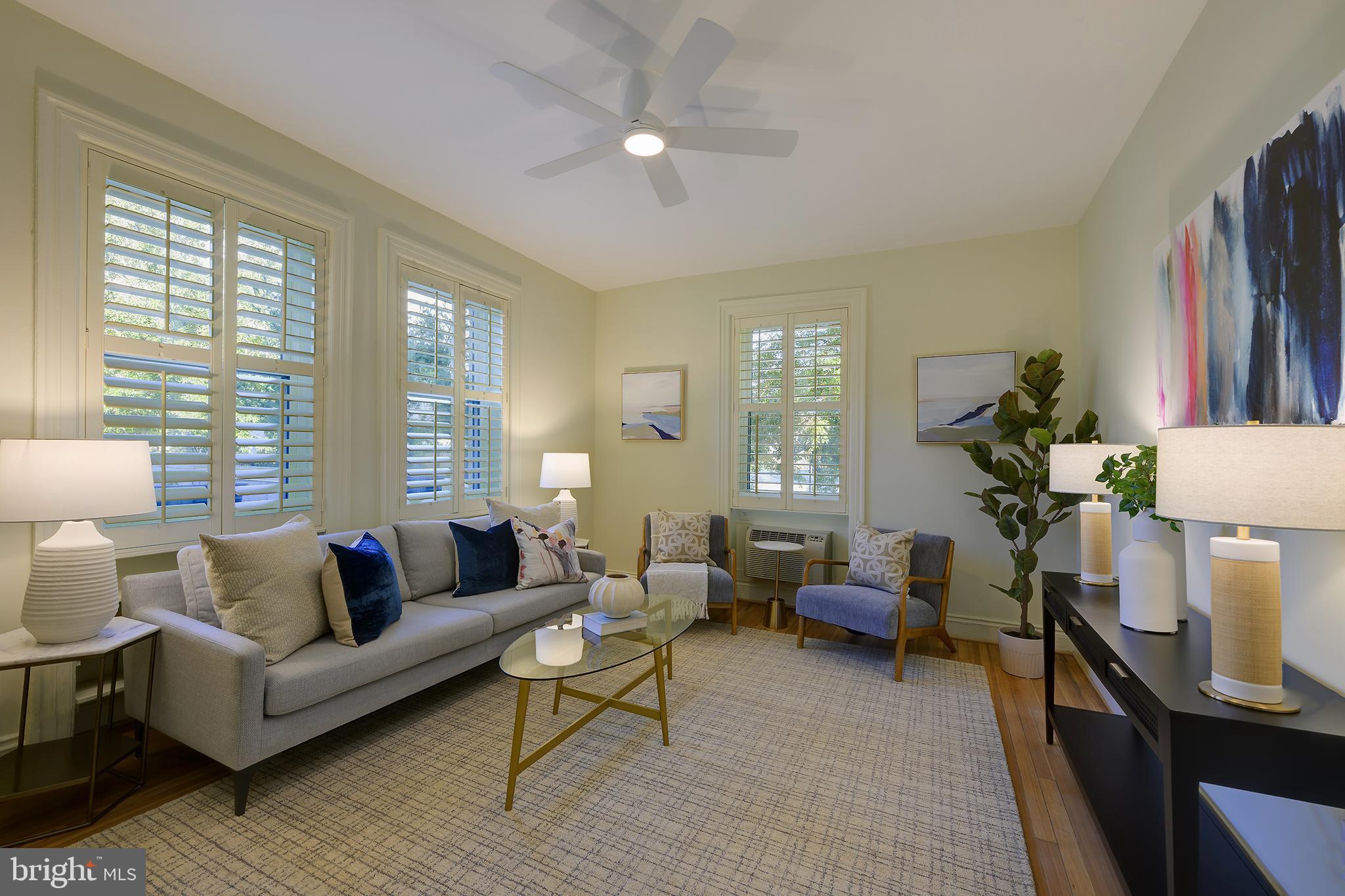 3100 Connecticut Avenue Northwest, Unit 145 Washington, DC 20008 - Photo 2 of 35 a living room with furniture a wooden floor and a large window