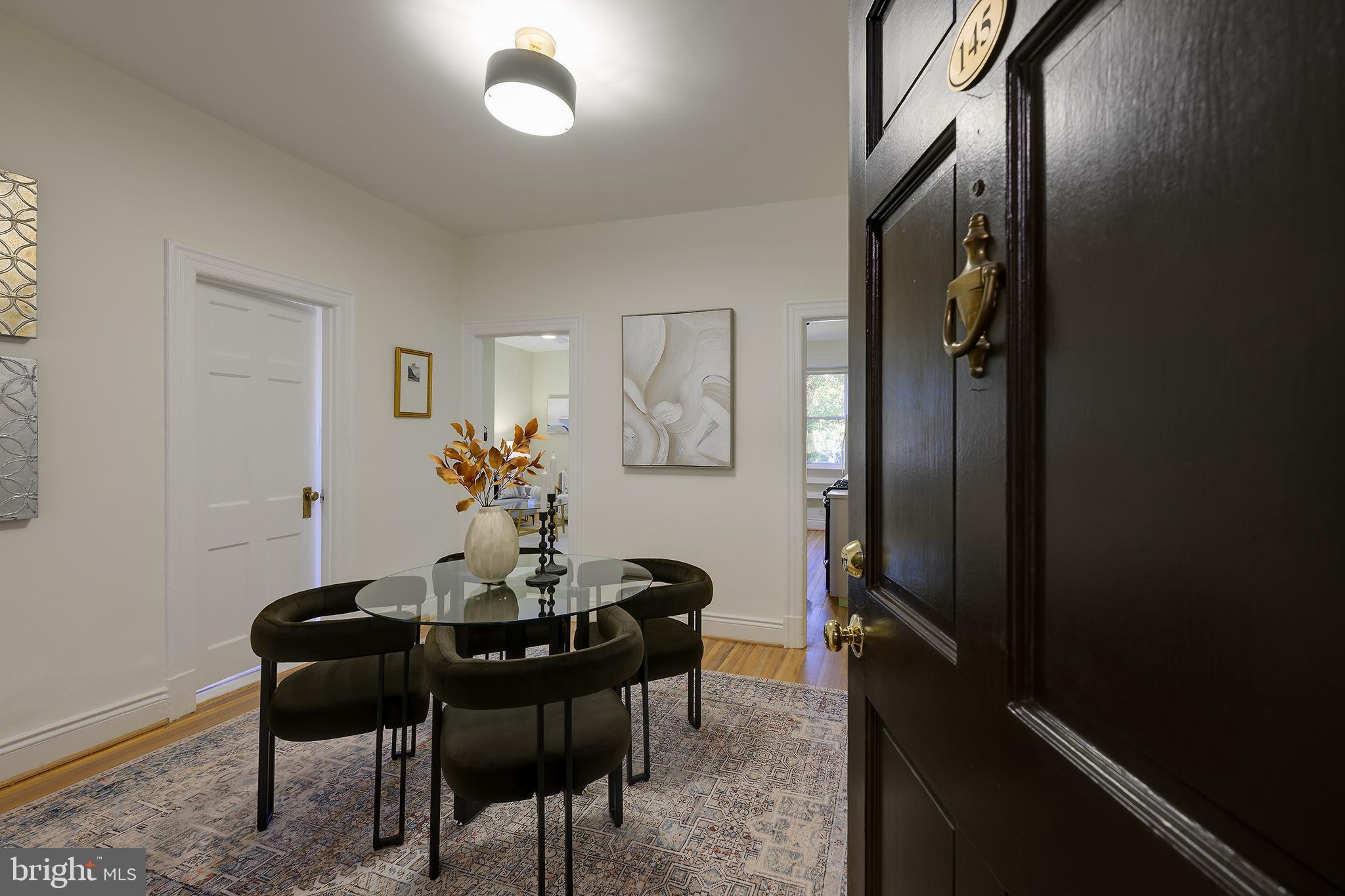 3100 Connecticut Avenue Northwest, Unit 145 Washington, DC 20008 - Photo 9 of 35 a view of a dining room with furniture and wooden floor