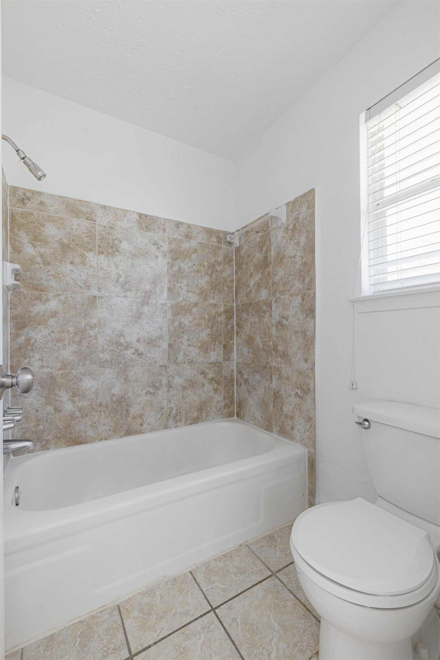 16702 Pebbleglen Drive Houston, TX 77095 - Photo 15 of 17 a bathroom with a toilet and a bathtub