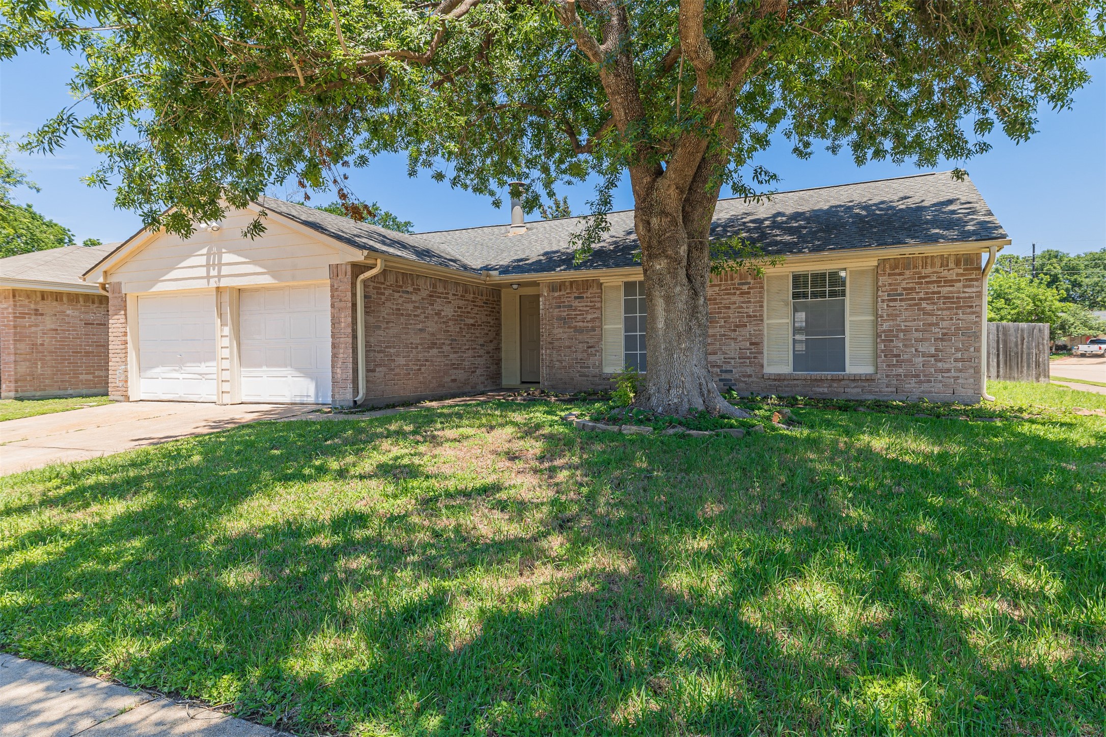 16702 Pebbleglen Drive Houston, TX 77095 - Photo 2 of 17 a front view of house with yard and green space