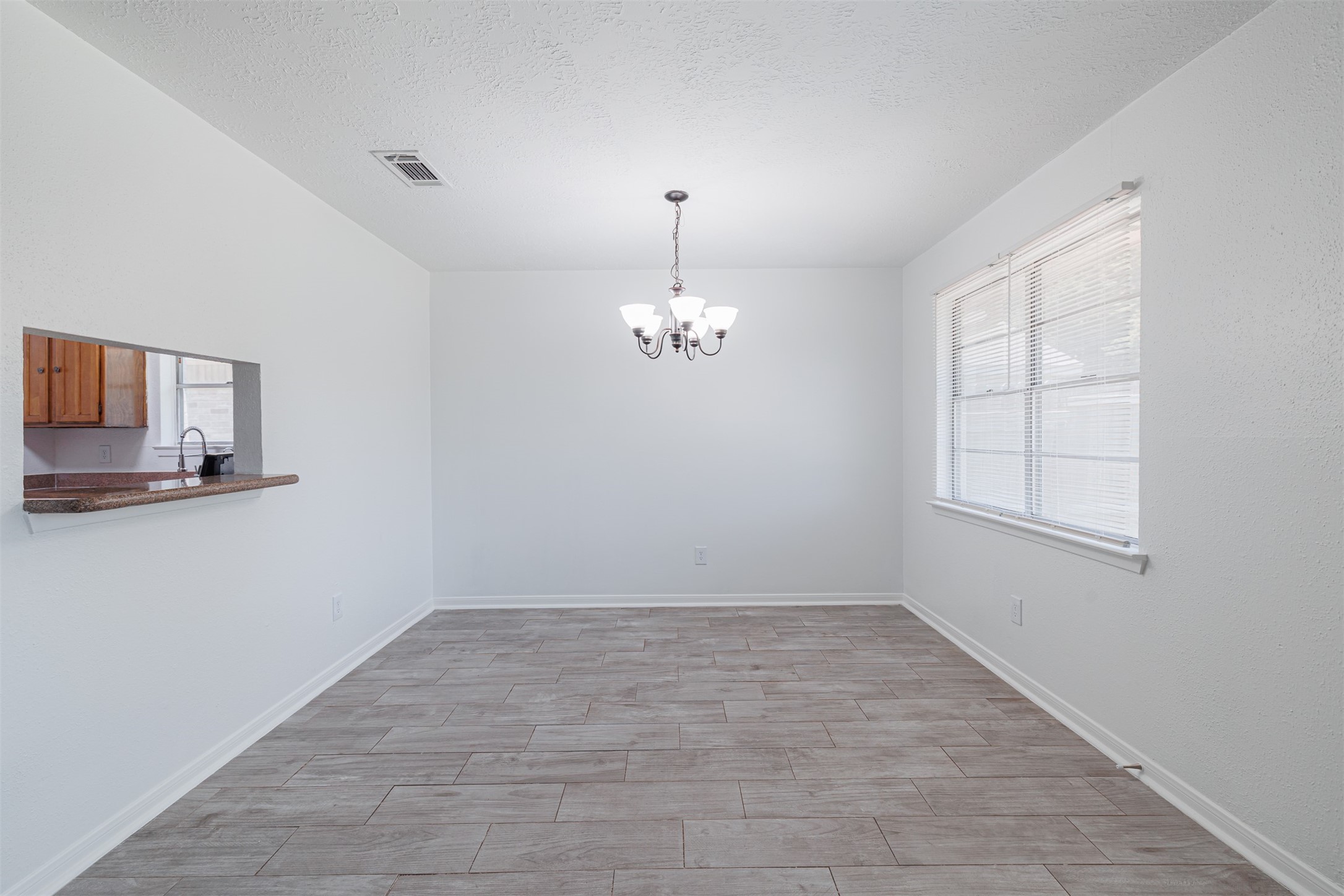 16702 Pebbleglen Drive Houston, TX 77095 - Photo 5 of 17 wooden floor in an empty room with a window