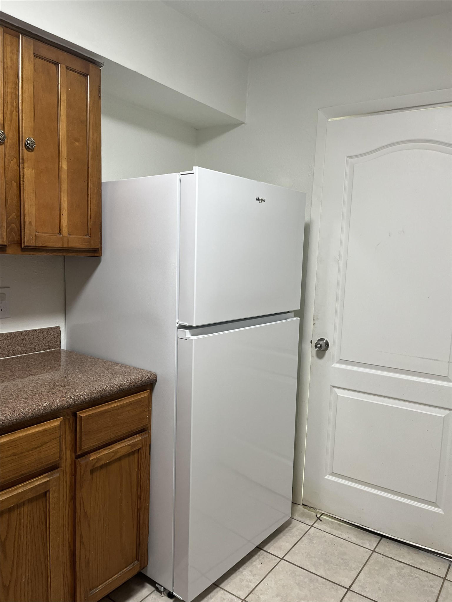 16702 Pebbleglen Drive Houston, TX 77095 - Photo 8 of 17 a kitchen with a refrigerator and cabinets