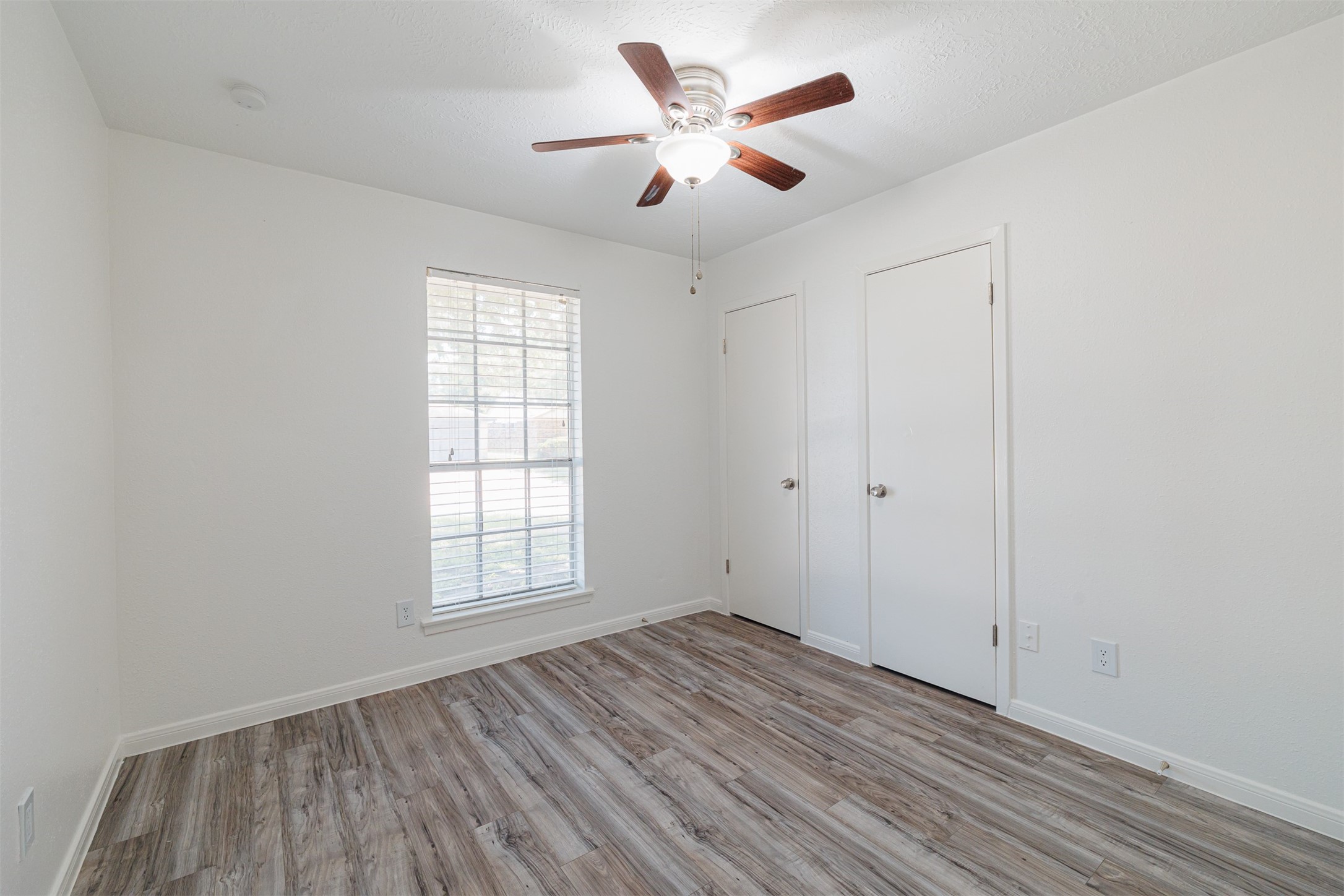 16702 Pebbleglen Drive Houston, TX 77095 - Photo 9 of 17 wooden floor in an empty room with a window