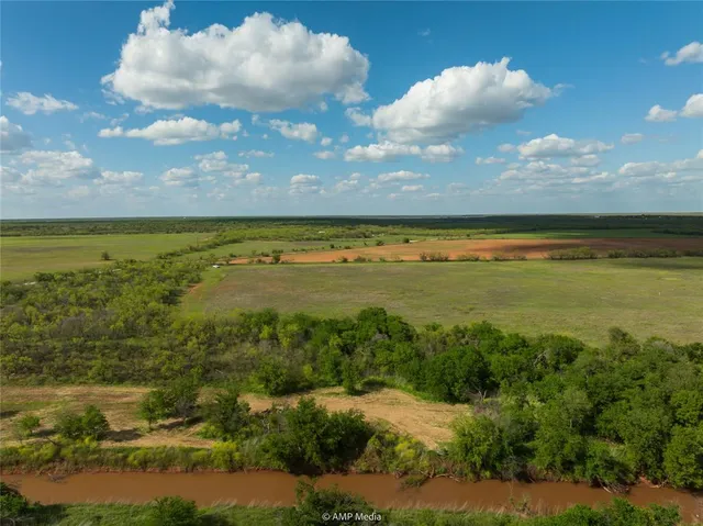 a view of a big yard with lots of green space