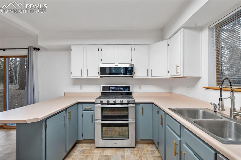 832 Spring Valley Drive Divide, CO 80814 - Photo 11 of 50 a kitchen with appliances a sink and cabinets