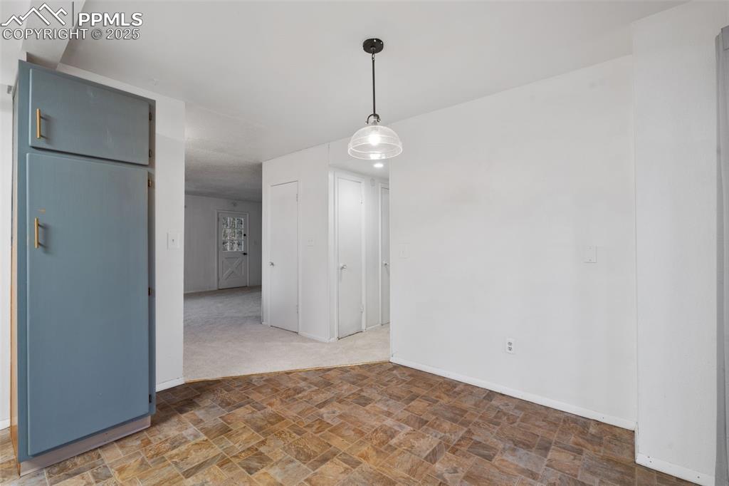 832 Spring Valley Drive Divide, CO 80814 - Photo 12 of 50 a view of a room with a chandelier fan and refrigerator