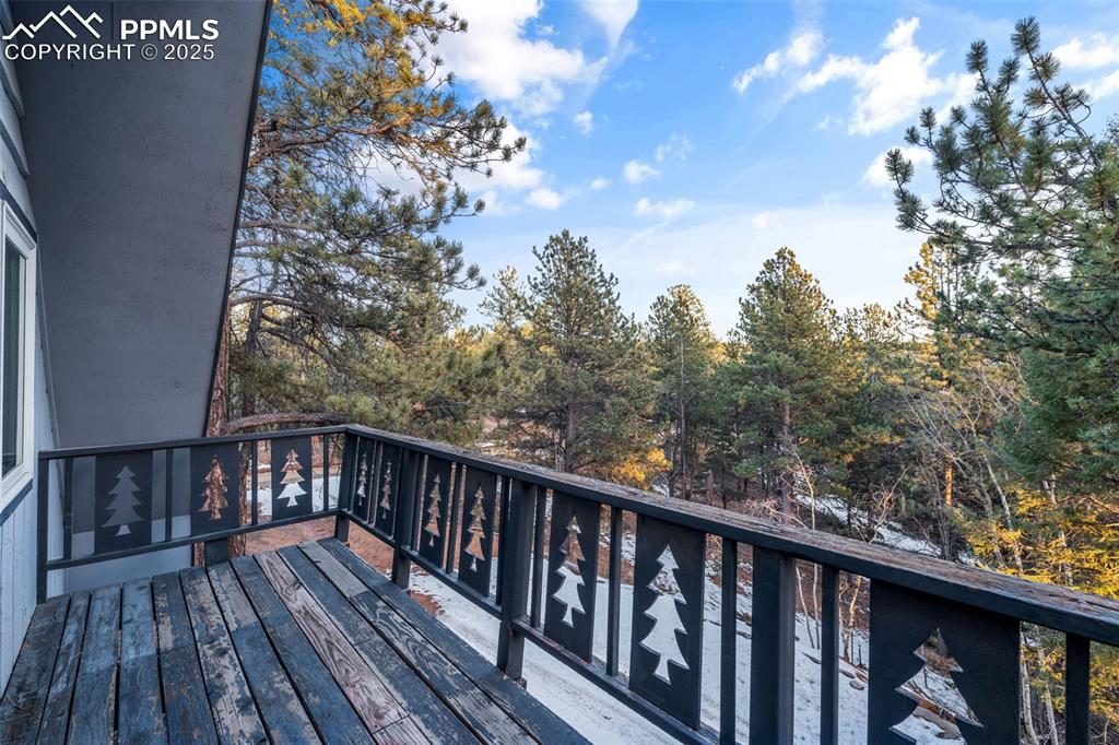 832 Spring Valley Drive Divide, CO 80814 - Photo 39 of 50 a balcony with wooden floor and fence