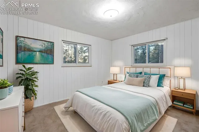 a bedroom with bed window and mirror