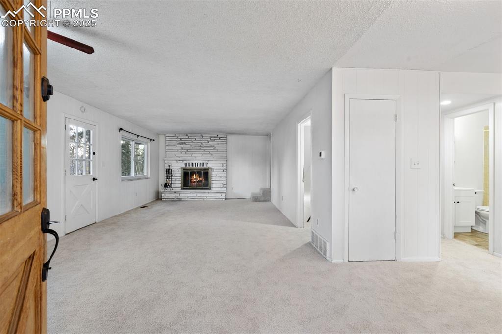 832 Spring Valley Drive Divide, CO 80814 - Photo 8 of 50 a view of a livingroom with a fireplace and window