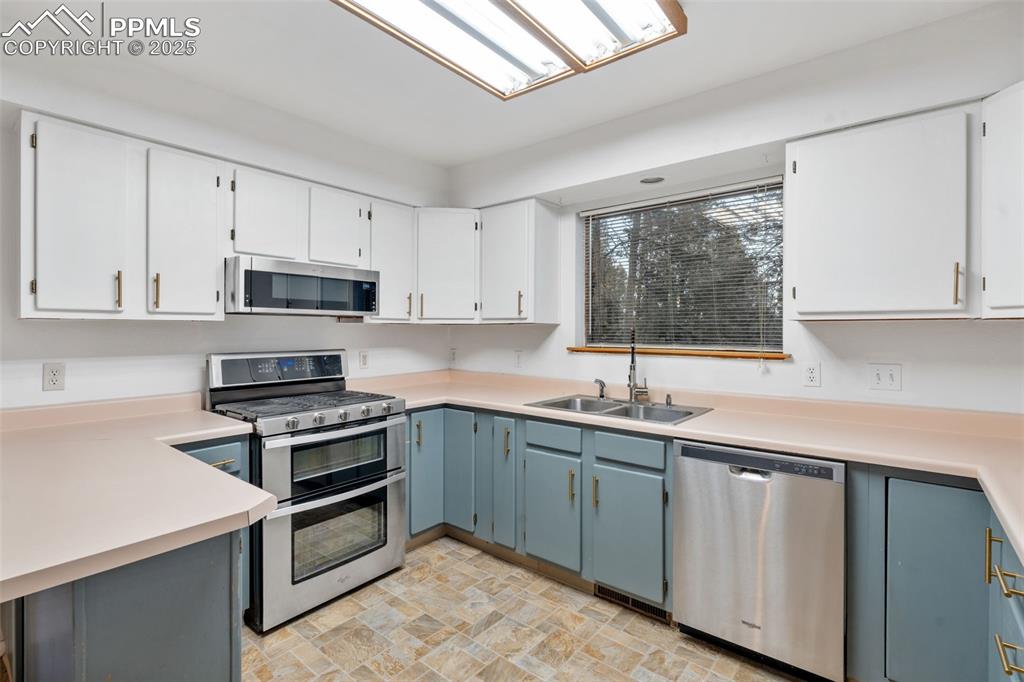832 Spring Valley Drive Divide, CO 80814 - Photo 9 of 50 a kitchen with cabinets appliances a sink and a window