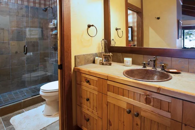 a bathroom with a sink a toilet and shower