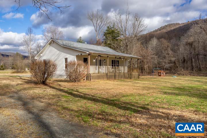 4657 Middle River Road Stanardsville, VA 22973 - Photo 3 of 40 a front view of a house with a yard and potted plants