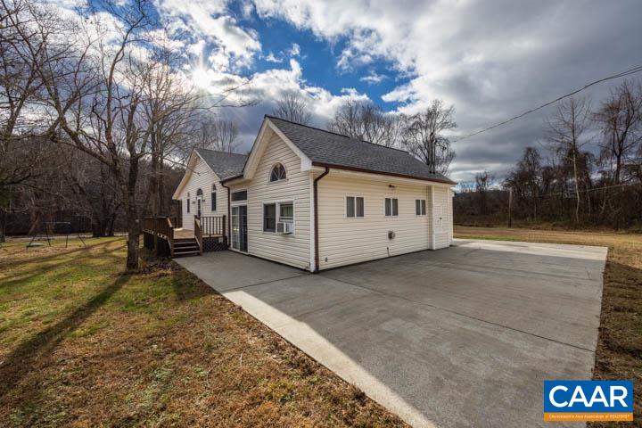 4657 Middle River Road Stanardsville, VA 22973 - Photo 5 of 40 a view of a white house with a big yard and large tree