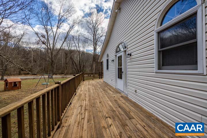 4657 Middle River Road Stanardsville, VA 22973 - Photo 8 of 40 a view of a balcony with wooden floor and fence and a pot