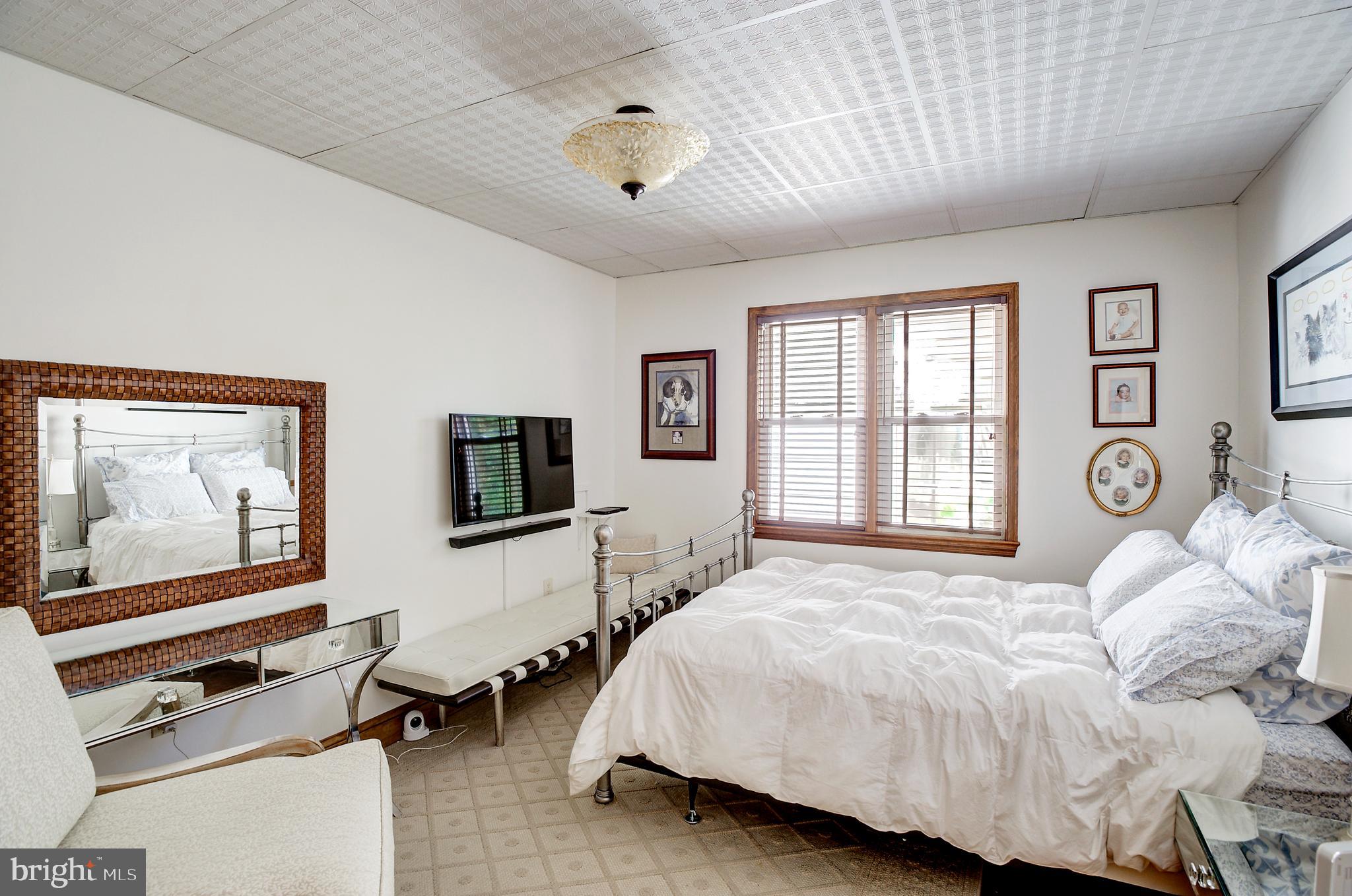 105 Franklin Road Glassboro, NJ 08028 - Photo 18 of 37 a spacious bedroom with a bed and a flat screen tv