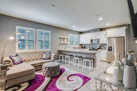 865 Orchid Way, Unit B Azusa, CA 91702 - Photo 4 of 12 a living room with stainless steel appliances furniture wooden floor and a kitchen view