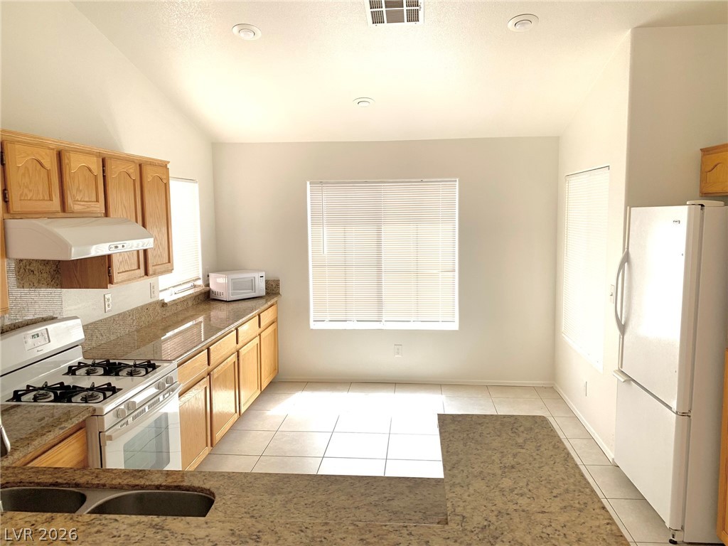 3821 Bombastic Court Las Vegas, NV 89147 - Photo 7 of 36 This spacious kitchen offers ample counter space, abundant cabinetry, and a functional layout.