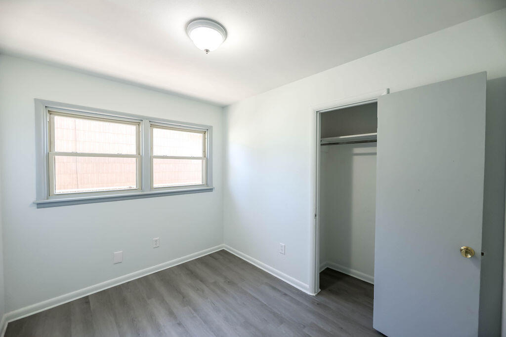 532 54th Street Lubbock, TX 79404 - Photo 16 of 19 an empty room with wooden floor and windows
