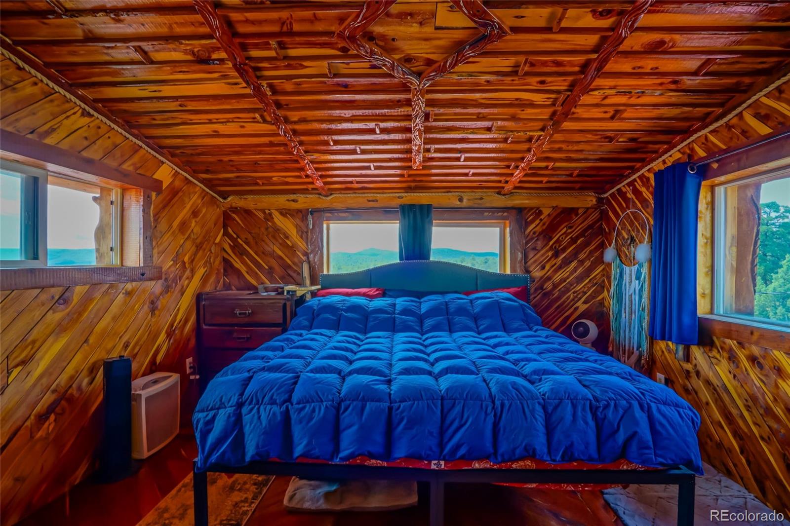 31300 Timber Canyon Road Trinidad, CO 81082 - Photo 30 of 50 a bed sitting in a bedroom next to a blue building