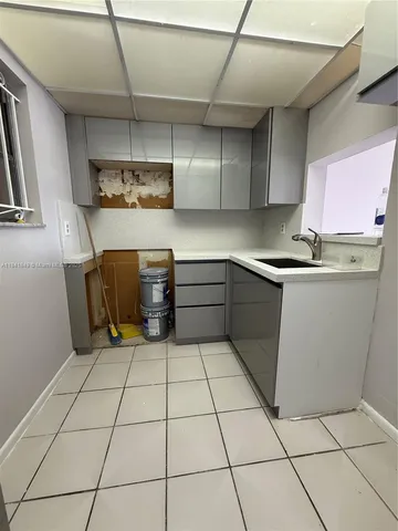 a kitchen with a cabinets and window