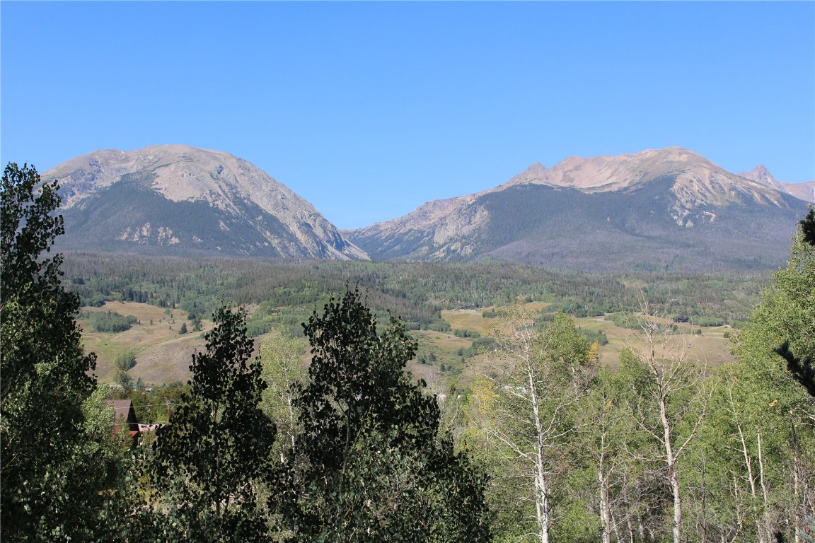 63 P Road Silverthorne, CO 80498 - Photo 4 of 20 a view of a mountain in the distance in a field