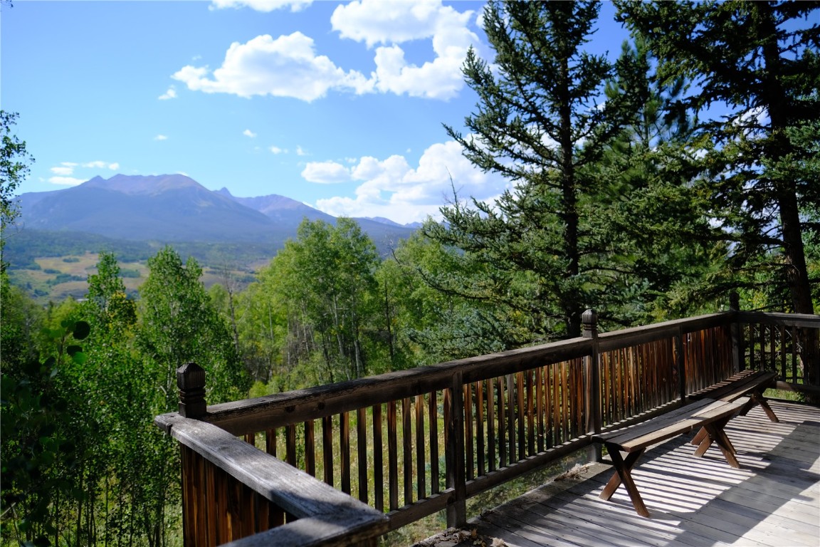 63 P Road Silverthorne, CO 80498 - Photo 6 of 20 a balcony with wooden floor and yard in the back
