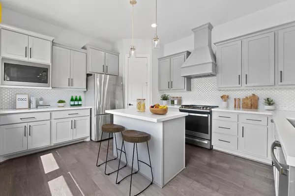a kitchen with white cabinets stainless steel appliances and sink