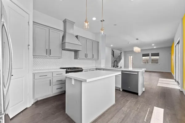 a kitchen with a stove a sink and a refrigerator