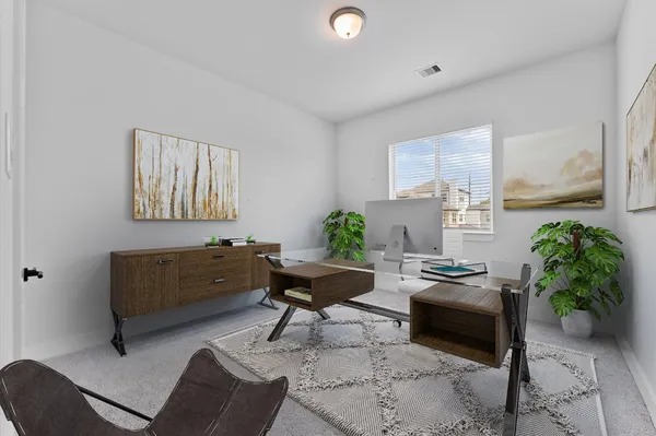 a living room with furniture and a potted plant