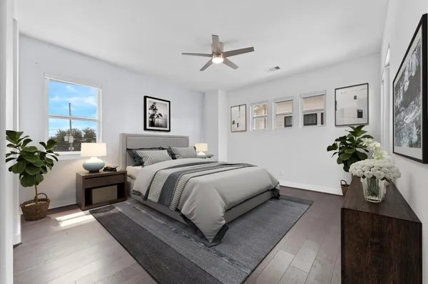 a bedroom with a large bed and potted plant