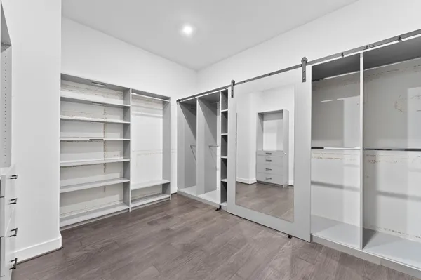 a view of walk in closet with empty racks