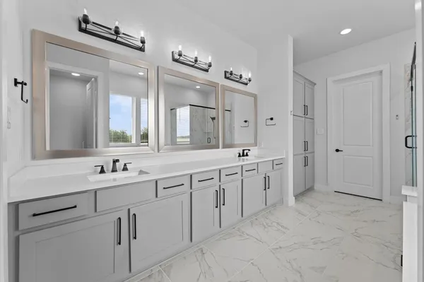 a spacious bathroom with a granite countertop sink mirror and a