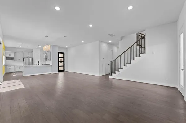 a view of an empty room with a kitchen