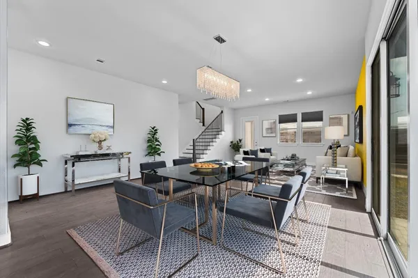 a living room with furniture kitchen view and a table