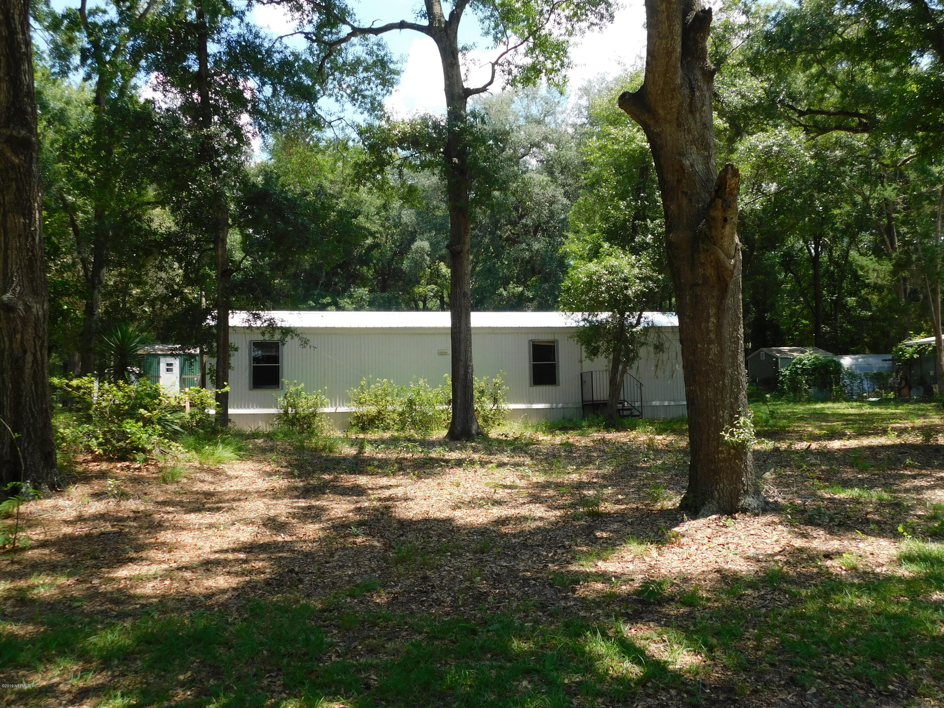 112 Cindy Street Interlachen, FL 32148 - Photo 3 of 33 a view of a house with backyard and trees
