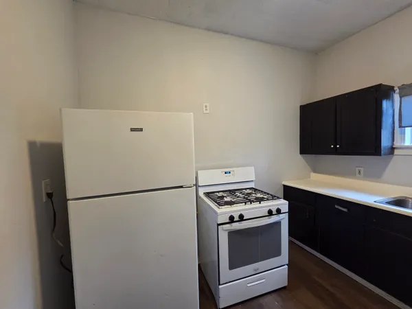 a kitchen with stainless steel appliances a refrigerator stove and microwave