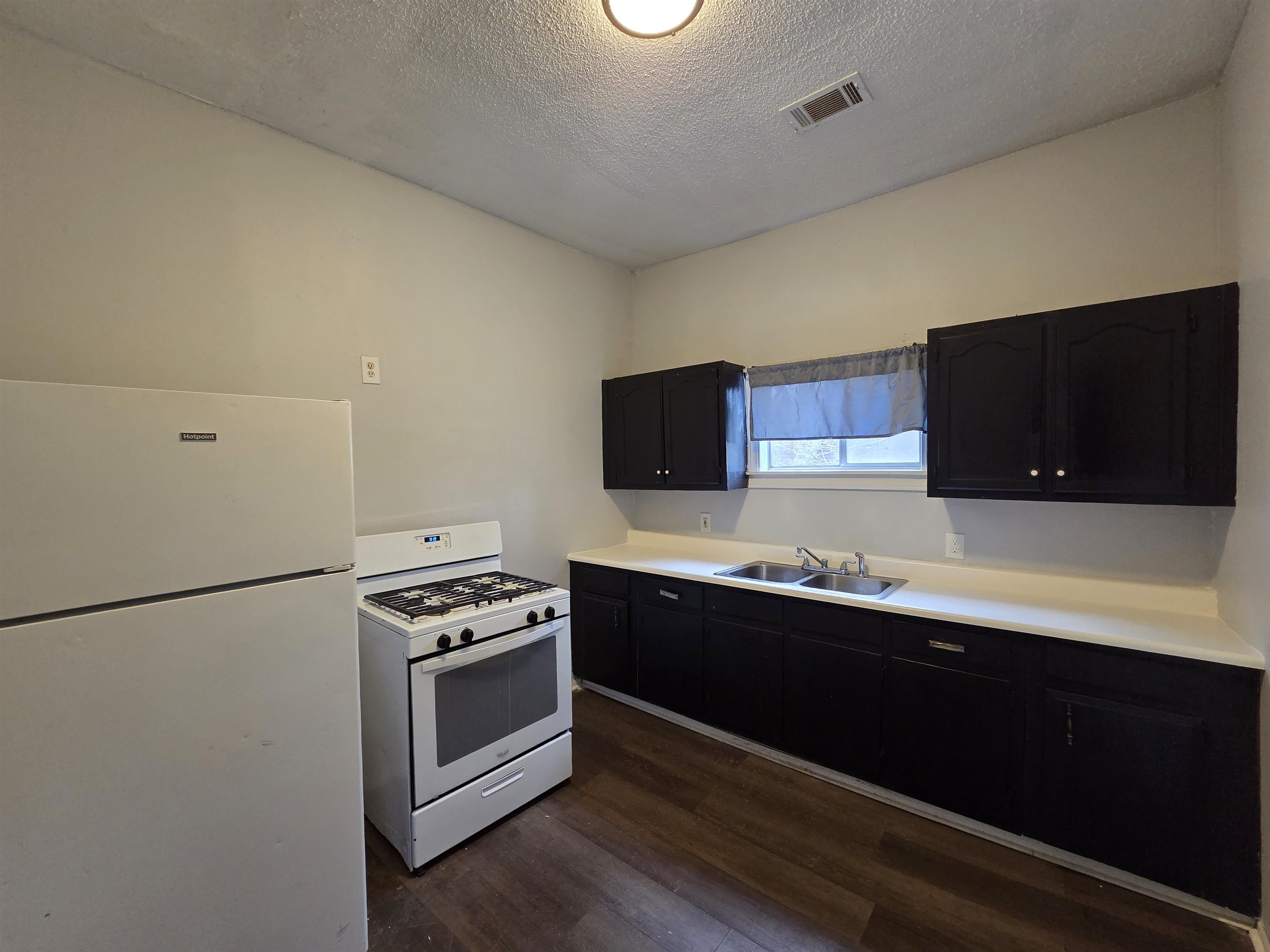 993 Oakview Street, Unit 201 Memphis, TN 38114 - Photo 12 of 16 a kitchen with stainless steel appliances a stove microwave and sink