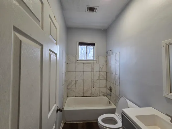 a bathroom with a tub and a sink