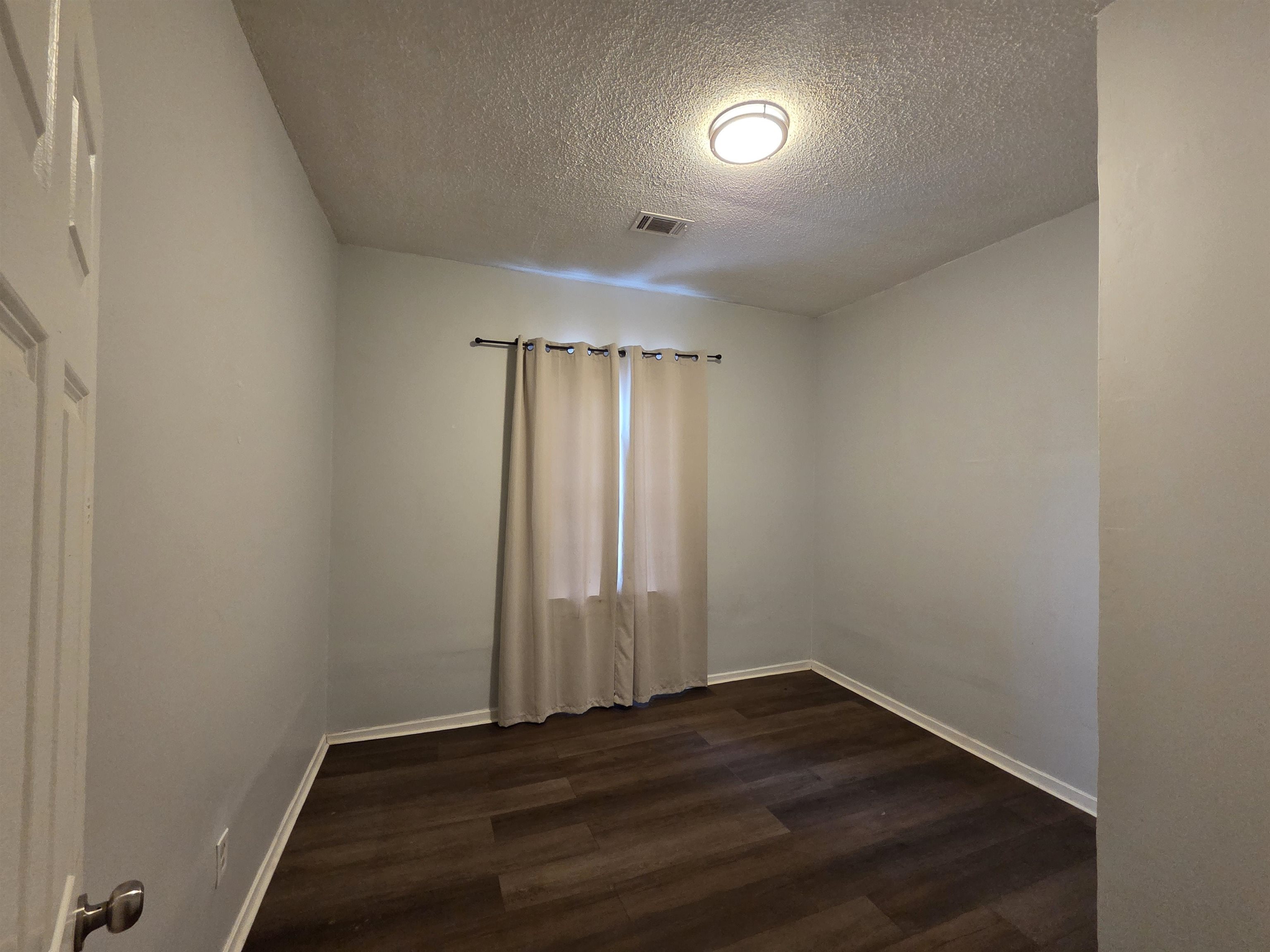 993 Oakview Street, Unit 201 Memphis, TN 38114 - Photo 6 of 16 an empty room with wooden floor and windows